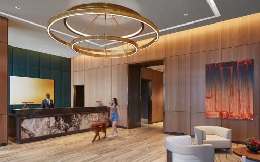 a rendering of a hotel lobby with a woman walking a dog and a man standing at the