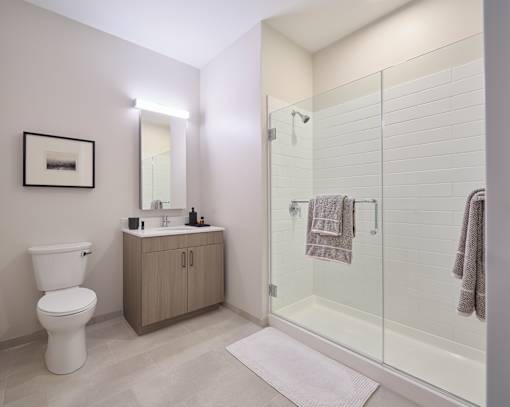 A bathroom with a toilet, sink, and shower.