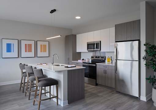 A modern kitchen with a white island and stainless steel appliances.