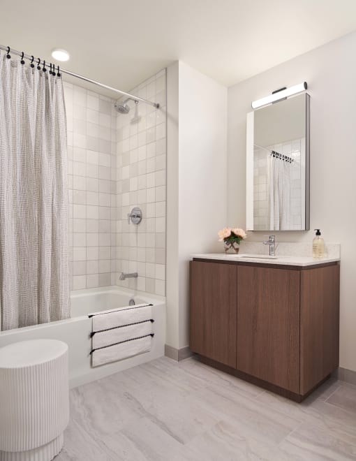 a bathroom with white walls and a white bathtub with a shower curtain