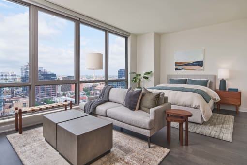 a bedroom with a bed and a large window