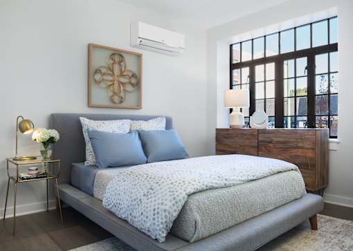 a bedroom with a bed and a window