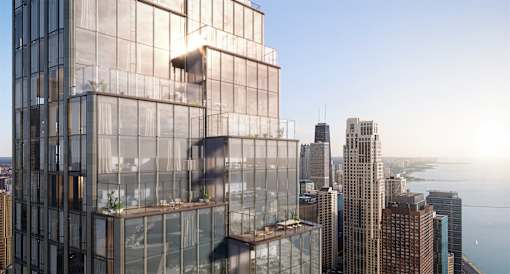 A modern glass building stands tall among other skyscrapers.