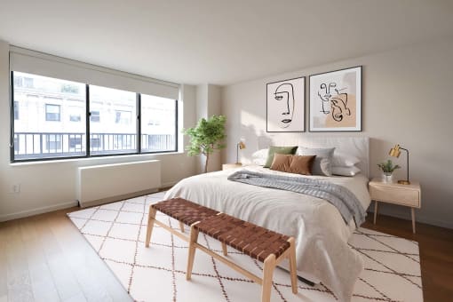 a bedroom with a bed and a large window