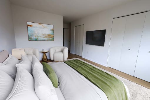 a bedroom with a large bed and a tv