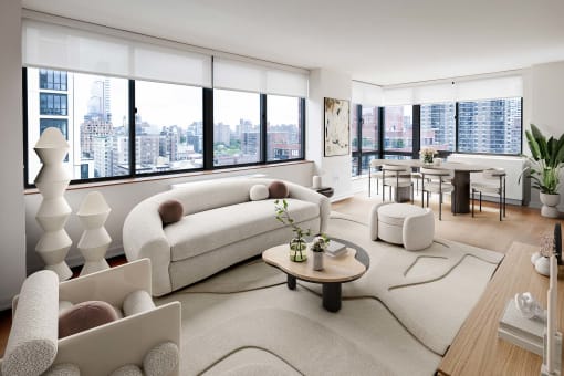 a living room with a view of a city and a couch and a table