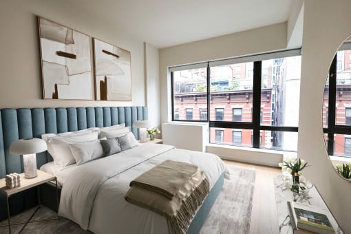 a bedroom with a large bed and a large window