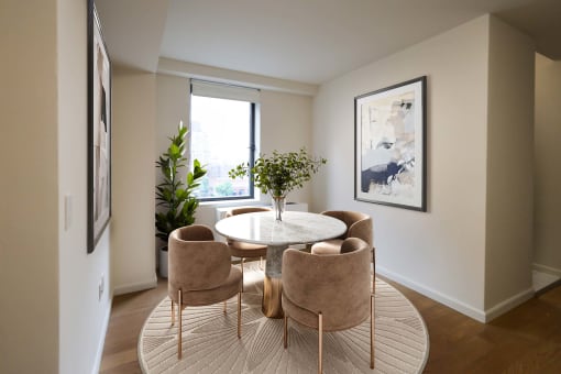 a dining room with a table and chairs and a window