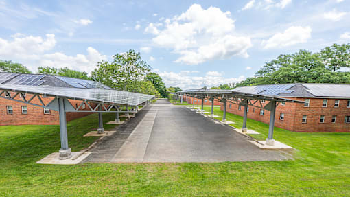 A long pathway with a row of buildings on either side.