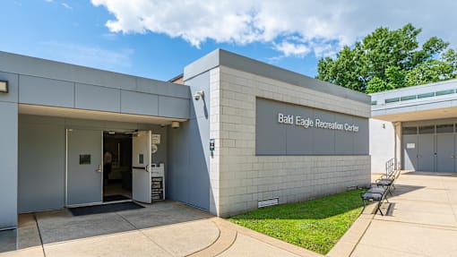 The Bald Eagle Reception Center is a modern building with a white exterior and a glass door.