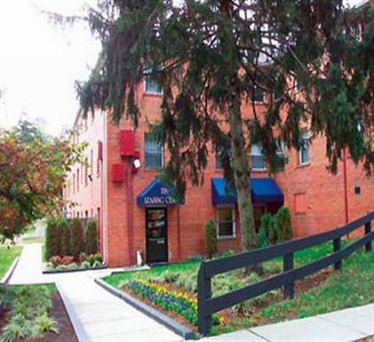 A red building with a blue awning and a black door.