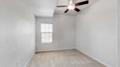 a white room with a ceiling fan and a window