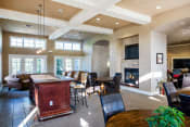 a large living room with a fireplace and a table and chairs