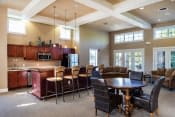 a large living room with a table and chairs and a kitchen