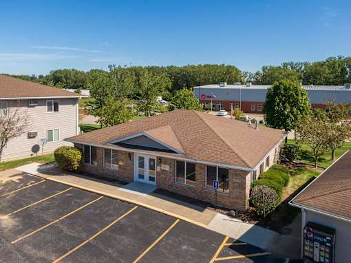 an aerial view of a building with a parking lot