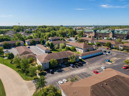 an aerial view of a neighborhood of houses with cars in a parking lot