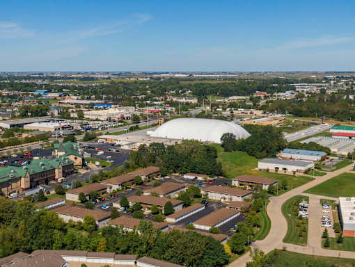 an aerial view of a city with a large dome in the background