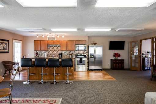 a kitchen with a bar in the middle of a living room