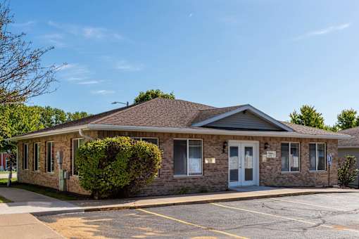 the front of a brick building with a blue door