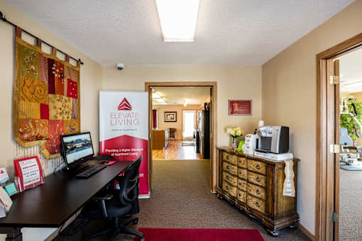 a office with a desk and a computer in a room