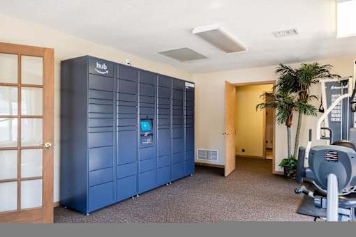 a gym with a blue locker room and machines