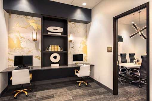 A black and white office with a gold and white marble wall at The Olivia Apartments, Carmel, IN