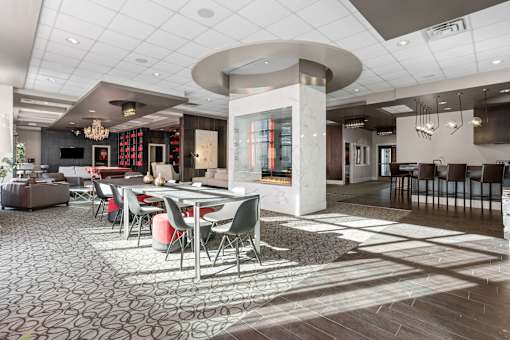 A modern dining room with a circular table and chairs.