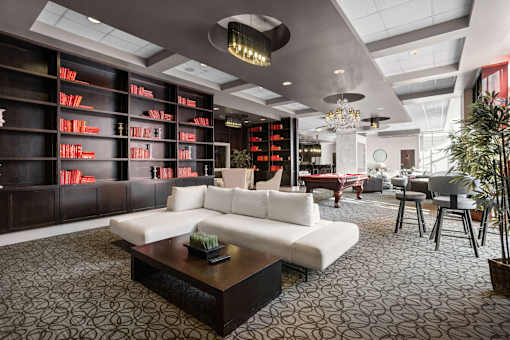 A modern living room with a white sofa and a patterned carpet.