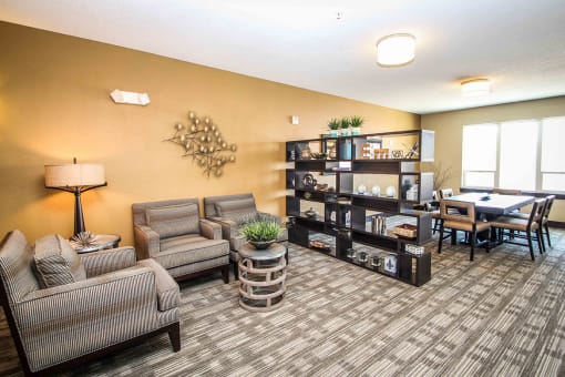 a common area with couches and a table at The Flats at Cedar Grove, Eagan