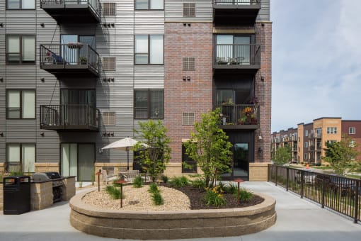 an outdoor courtyard with trees and plants  at Victoria Park and V2 Apartments, St. Paul