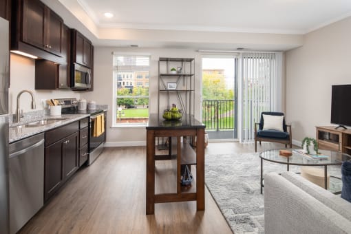 View of kitchen and living room area looking onto the balcony  at The Whitley, St. Paul, MN