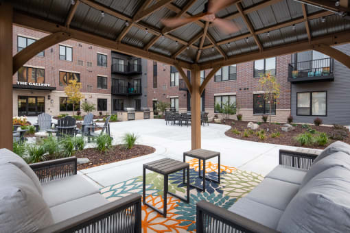 an outdoor lounge area with couches and tables at The Gallery Apartments, Burnsville