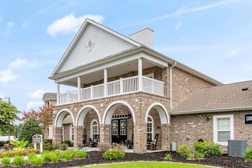 A house with a balcony and arched doorways.