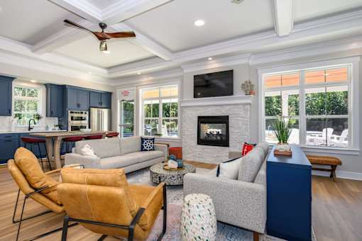 A living room with a fireplace and a television at The Promenade at Easton Apartments, Easton, 21601