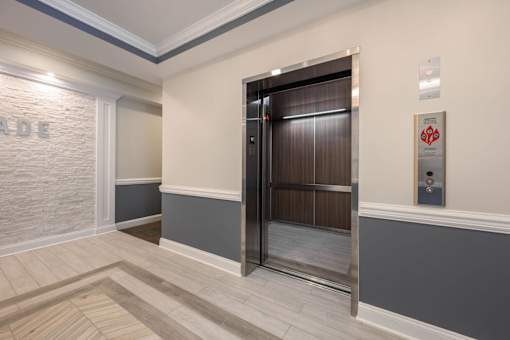 A room with a wooden floor and a metal door at The Promenade at Easton Apartments, Easton, MD 21601