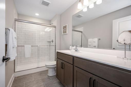 A bathroom with a toilet, sink, and shower at The Promenade at Easton Apartments, Easton Maryland