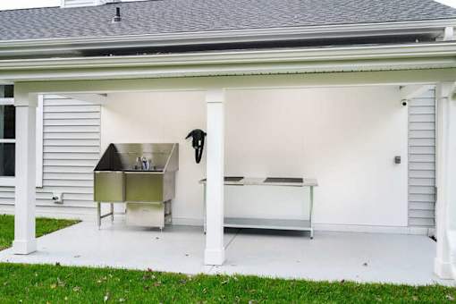 A white garage with a white door and a white bench inside at The Promenade at Easton Apartments, Maryland