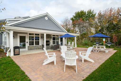 A house with a patio and chairs at The Promenade at Easton Apartments, Easton Maryland