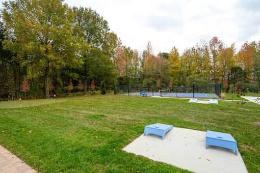 A park with a blue bench and a white bench at The Promenade at Easton Apartments, Easton, MD
