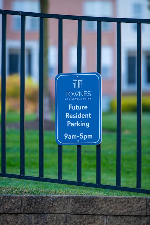 a blue parking sign at Townes at Village Center Apartments, Reisterstown, MD, 21136
