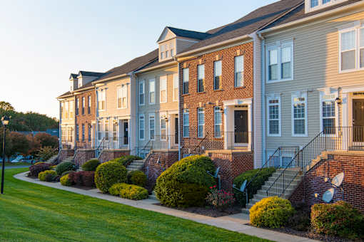 Building exterior with garden at Townes at Village Center, Reisterstown, 21136