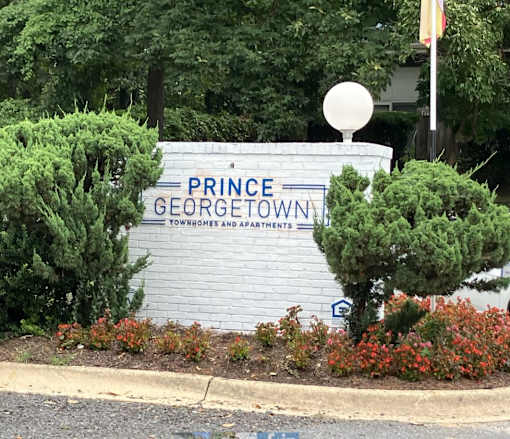 A sign that says Prince George Townhomes and Apartments.