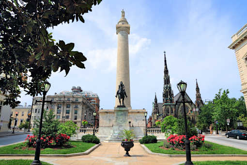 a tall column with a statue in the middle of a city street at Queen Anne Belvedere, Baltimore, 21201
