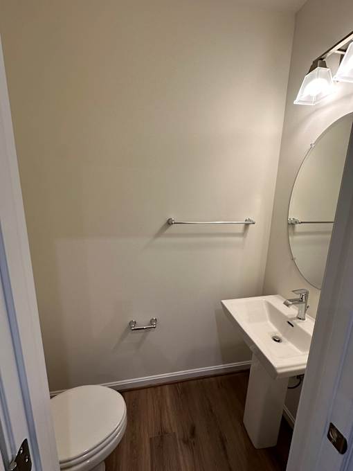A white sink in a small bathroom.