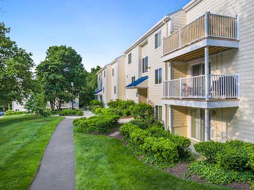 A building with a balcony and a walkway in front of it. at West Woods, Annapolis