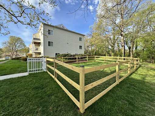 A house with a white fence and a green lawn. at West Woods, Annapolis, Maryland