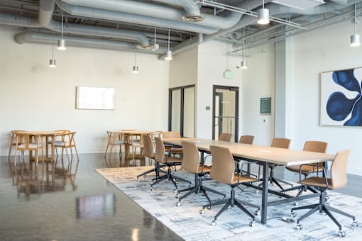 A conference room with a long table and chairs.