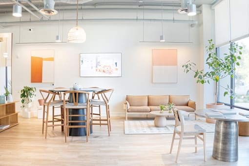A modern living room with a wooden table and chairs.