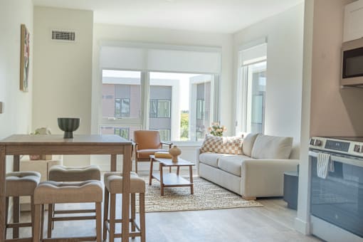 A modern living room with a dining table and chairs.