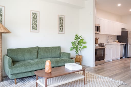 A living room with a green couch and a coffee table.